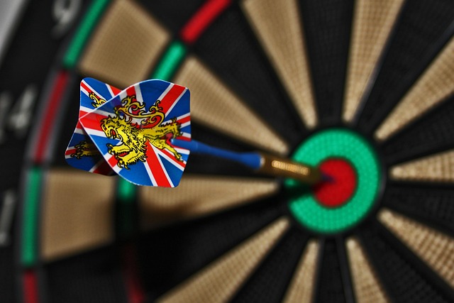Darts training setup showing a dartboard with practice targets and a scoring app on a tablet