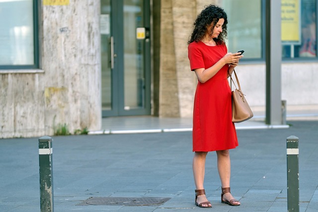 Person looking tiredly at a clock and phone screen late at night